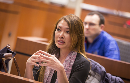 Cat Burkat, MD, asks a question during oculoplastics grand rounds presentation