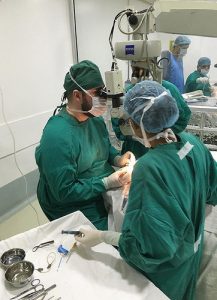 Brandon Metcalf, MD, third year UW ophthalmology resident, performing surgery in the operating room at Shroff’s Hospital.