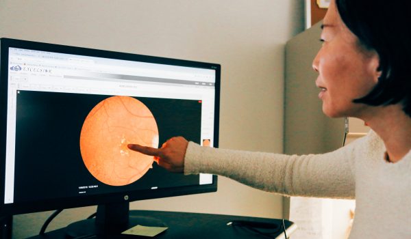 Woman Points to an Eye on a Computer