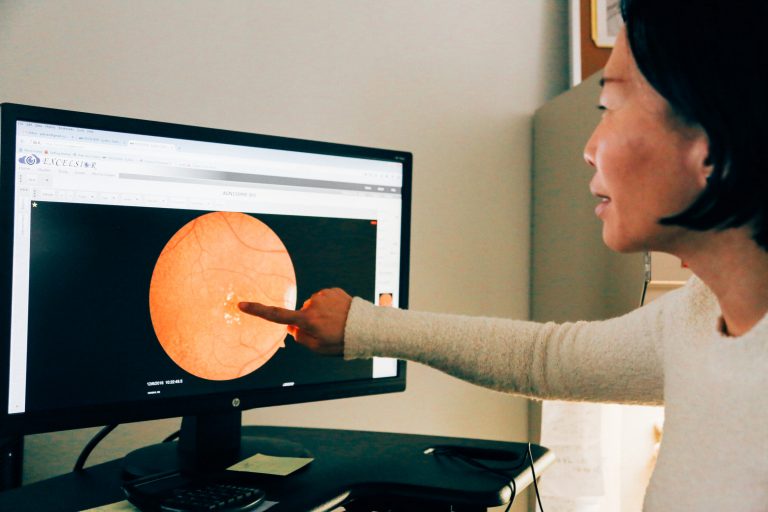 Woman Points to an Eye on a Computer