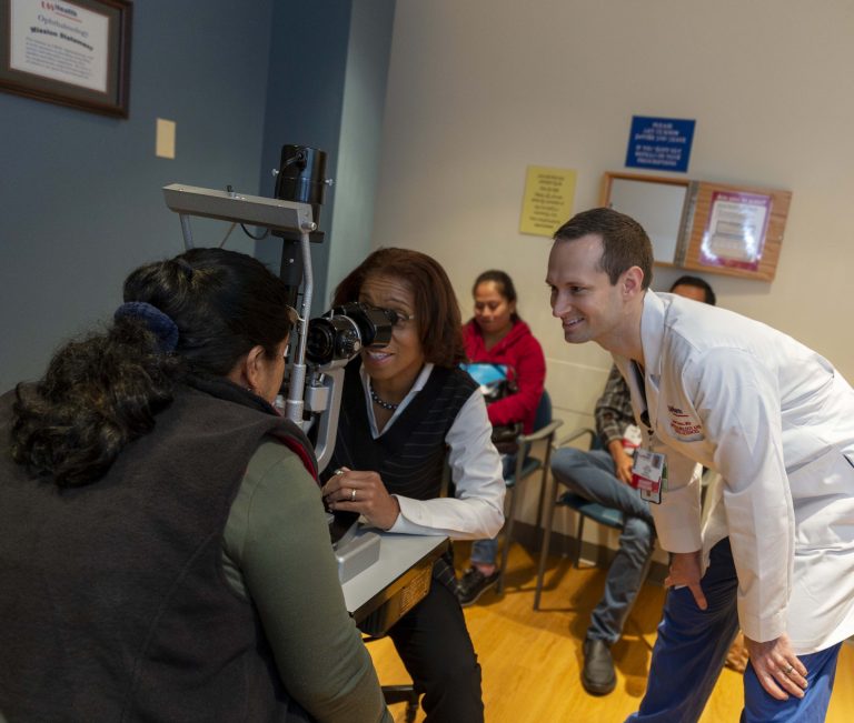 Dr. Terri Young examines patient with resident.