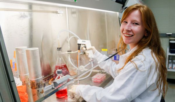 Sarah Ferguson works under the hood in Curtis Brandt's infectious disease-studying lab.