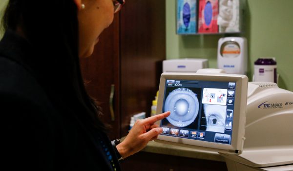 Yao Liu, MD, examines a rural WI patient's eye photo remotely using tele-ophthalmology services.