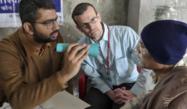 Resident, Dr. R. Chris Bowen observers eye exam at outreach clinic in New Delhi, India during rotation February 1-15, 2019.