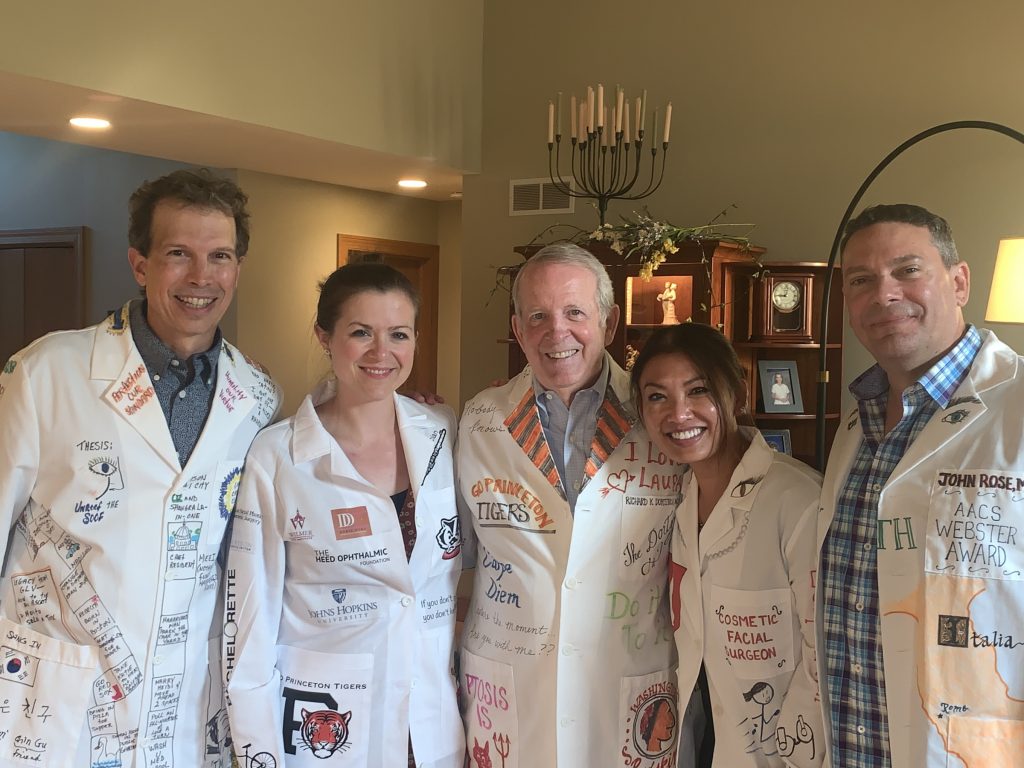 Pictured from left to right: Drs. Mark Lucarelli, Suzanne van Landingham, Richard Dortzbach, Cat Burkat and John Rose. On Saturday, July 20, the oculoplastics team and alumni celebrated one of the time-honored traditions of the  UW-Madison Oculofacial fellowship, the White Coat Celebration.