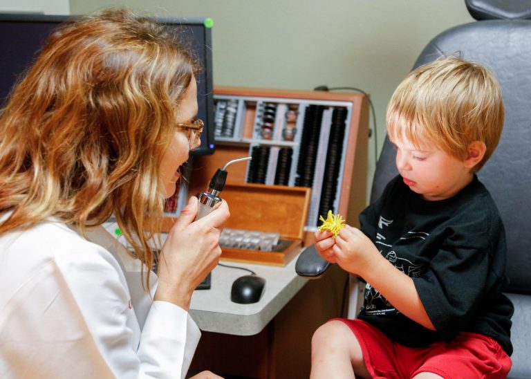 Dr. Melanie Schmitt evaluating a pediatric ophthalmology patient