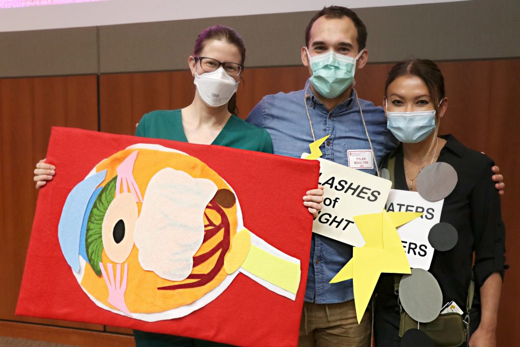 Instructors Elaine Downie, Tyler Boulter and Cat Burkat pose for a photo with their homemade props.