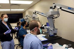 Residents (class of 2023) Katherine Dalzotto, Chintan Pathak, MD, and William Van De Car, MD participate in the Global Fieldwork Simulation Wet Lab January 6, under the direction of Jenny Larson, MD.