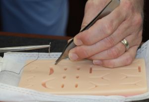 hands practicing sutures