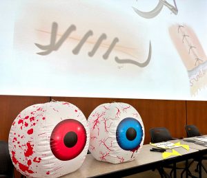 2 large inflatable eyeballs on a table