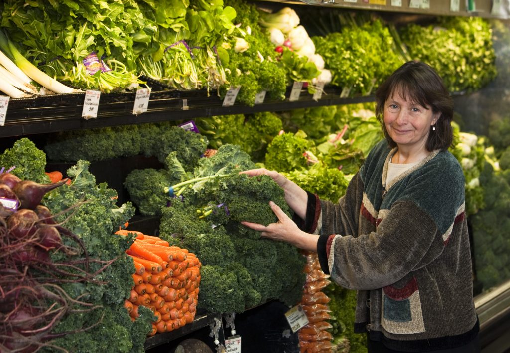 Dr. Mares in produce department of a grocery store.