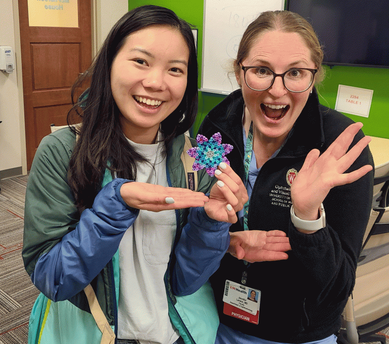two women show off their crafts