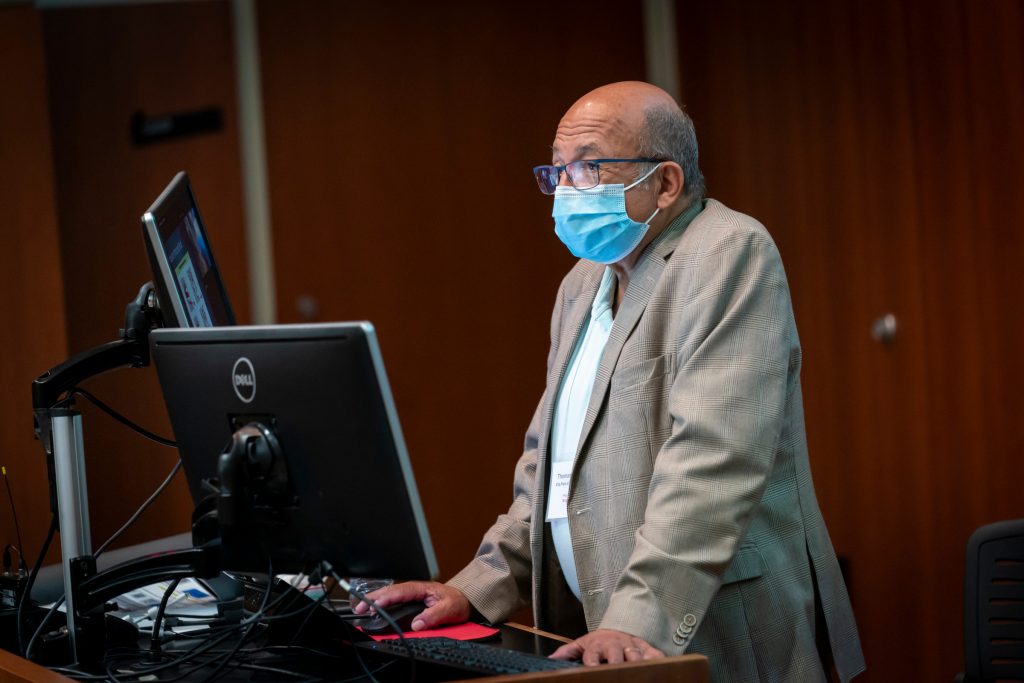 professor wearing a mask delivering a lecture