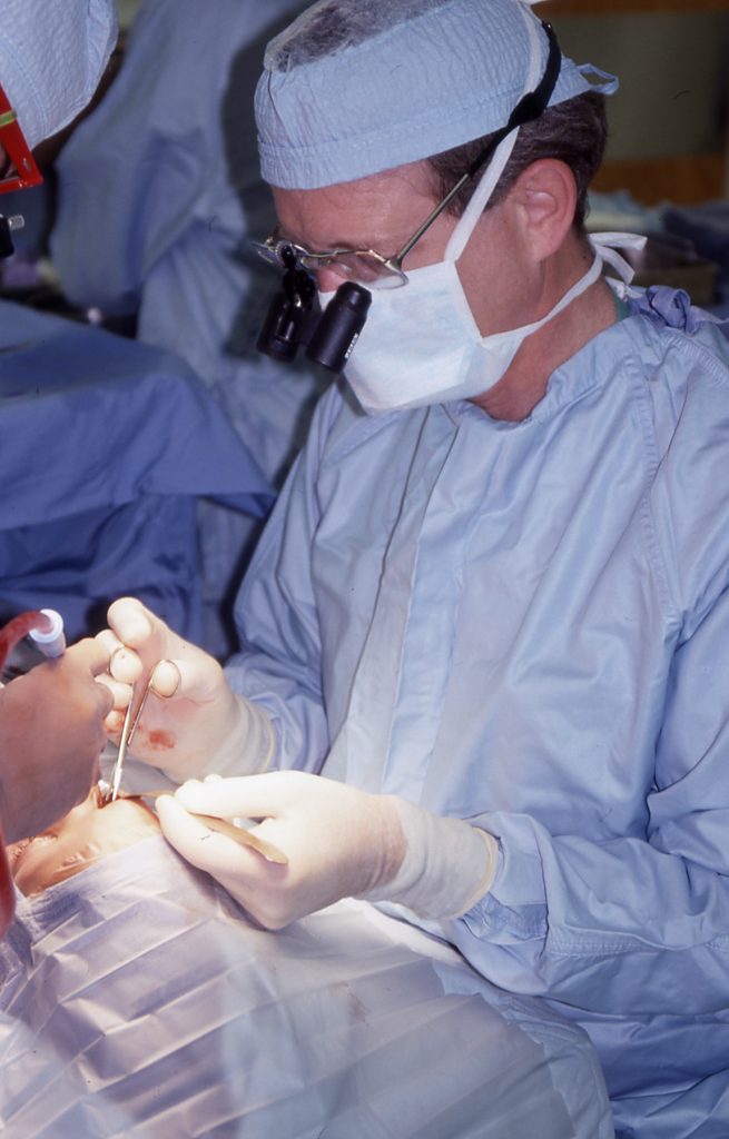 man in blue surgical scrubs in the operating room