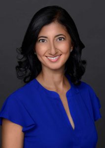 woman with dark hair in blue shirt