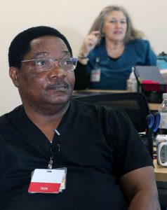 man in black scrubs in a classroom