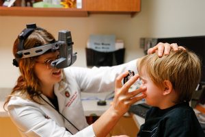 Dr. Melanie Schmitt with young patient at IRD clinic