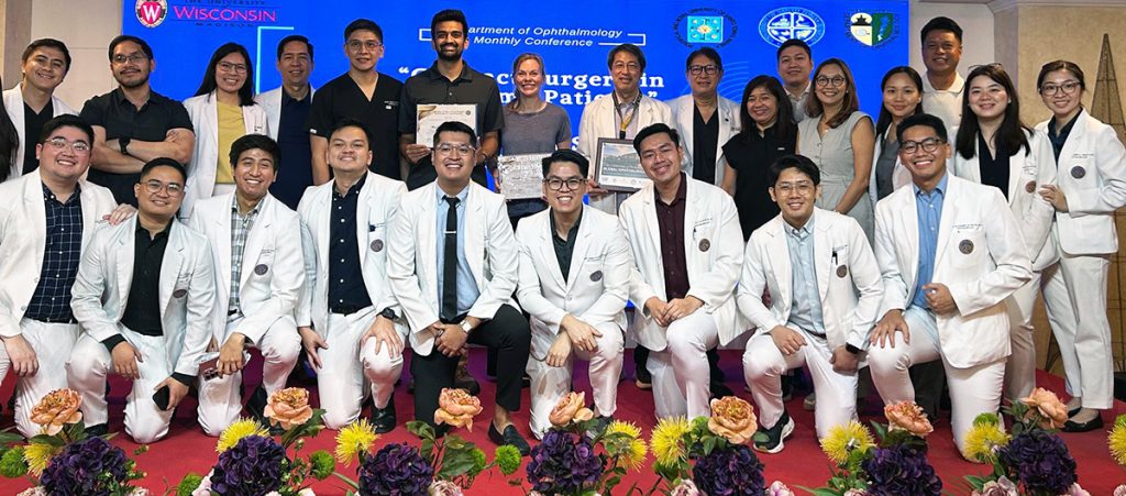 large group of people, many wearing white doctors' coats