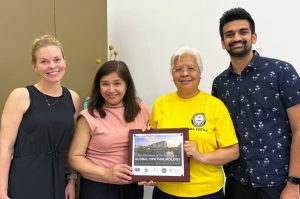 four people holding a certificate