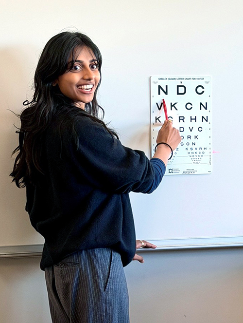 woman pointing to an eye chart
