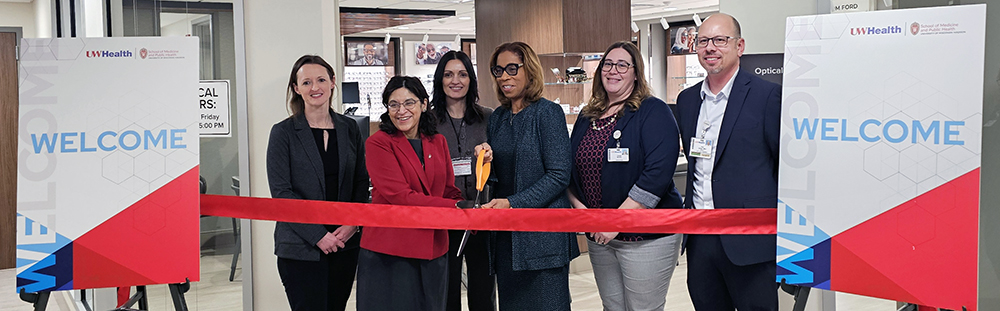 individuals in between signs that read 'Welcome"