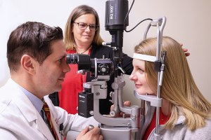 Dr. Mititelu and Director Angie exam Kelly Boyd's eyes