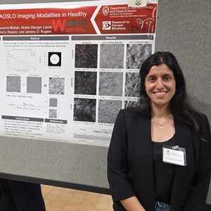 woman with dark hair in front of a poster