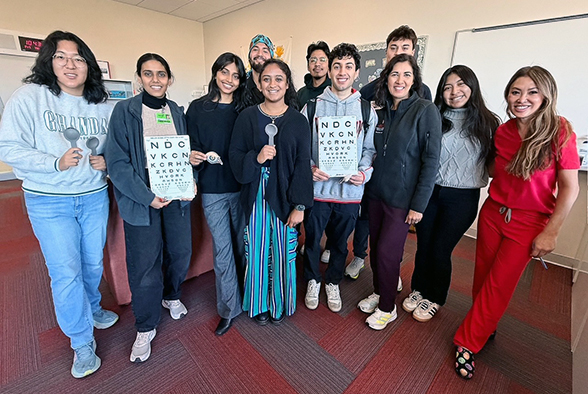 a group holding an eye chart